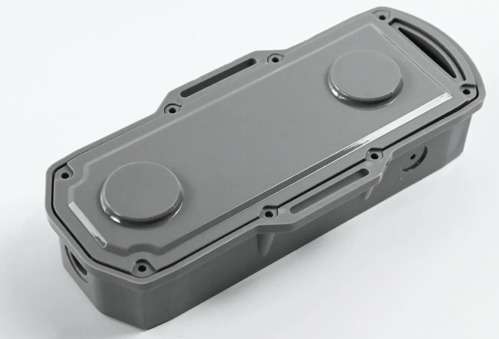 Injection-molded gray plastic electronic enclosure with sealed screw bosses and cable ports.