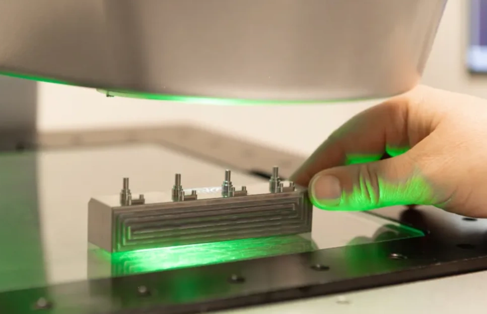 Green laser scanner inspecting micro-machined connector pins for dimensional accuracy