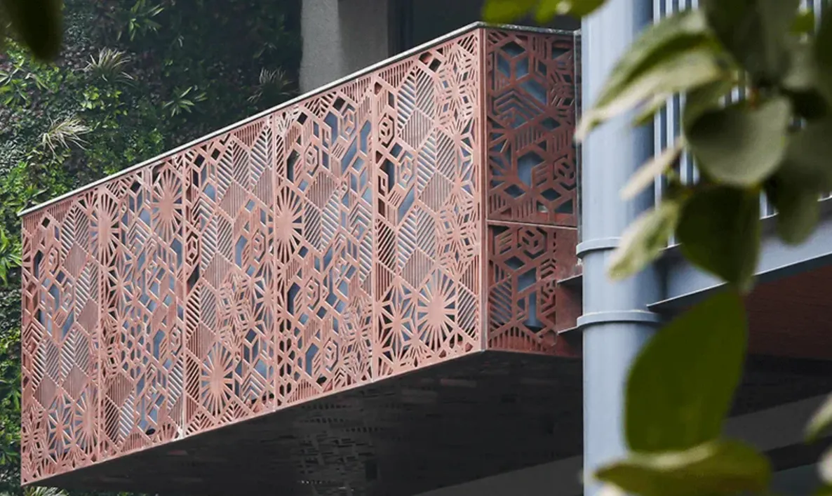 Architectural building facade with intricate laser-cut copper geometric hexagon screen panels