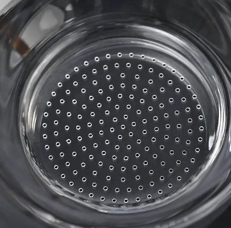 Precision array of micro-drilled holes patterned into round glass surface