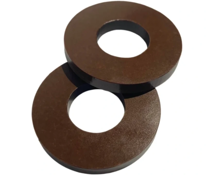 Two overlapping brown paper phenolic washers with center bore holes