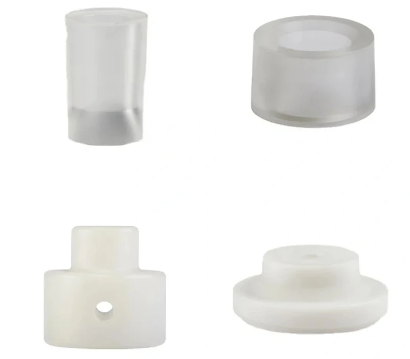 Four CNC-turned polypropylene parts, translucent and opaque finishes
