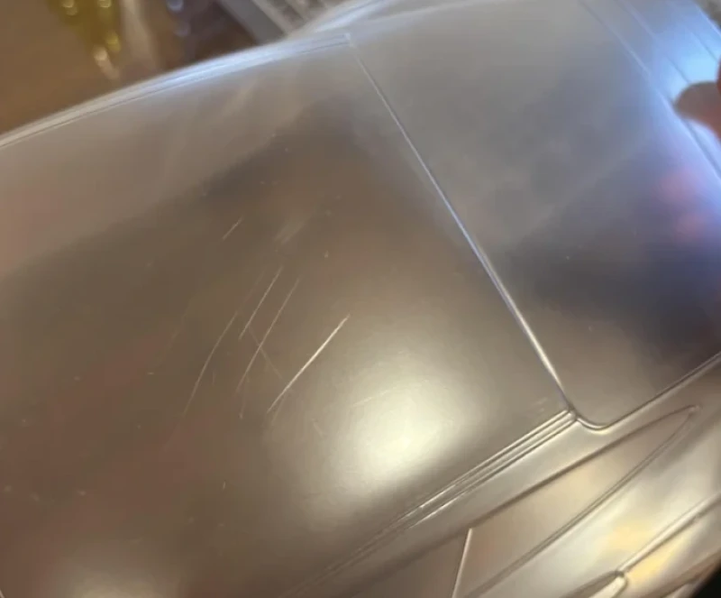 Close-up of visible surface scratches on polycarbonate plastic panel 