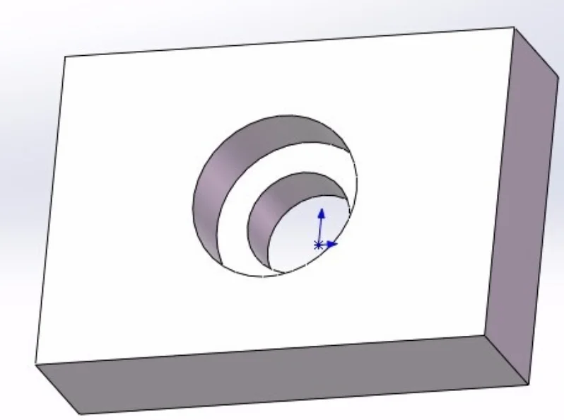 CAD model of a rectangular block with a stepped counterbore hole showing a wide recess and a narrower through hole