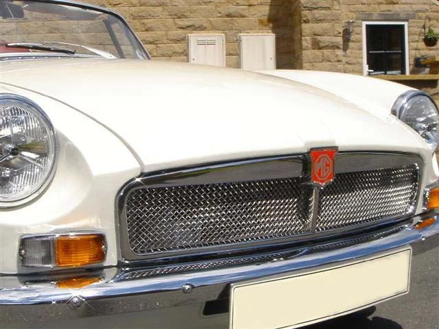 Bright, reflective metal mesh grille on a vintage convertible