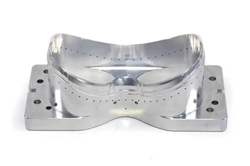 CNC-machined steel mold with contoured cavity and precision drilled hole patterns
