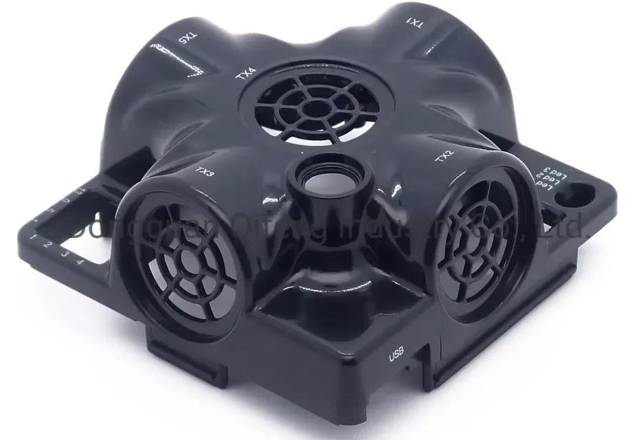 Black injection-molded plastic drone housing with four vented speaker grilles and a USB port.